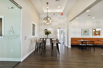 A dining room with a table and chairs in front of a glass door